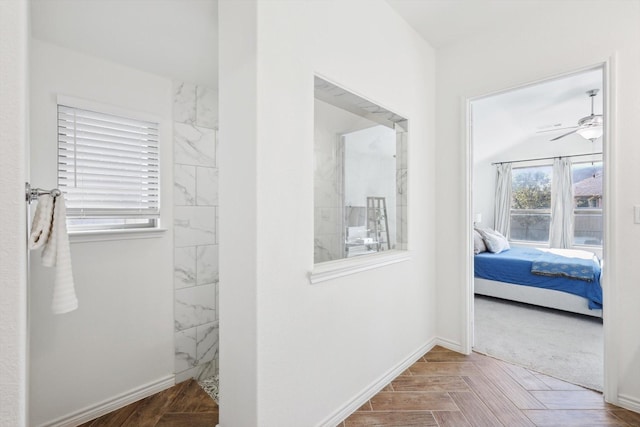 interior space with a shower, parquet flooring, and ceiling fan