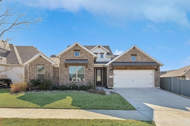 view of front of house featuring a garage and a front lawn