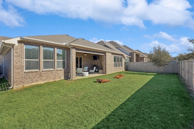 back of property featuring a yard and a patio area