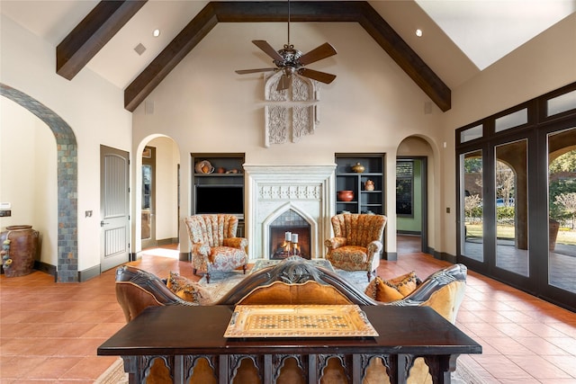 sitting room featuring french doors, beam ceiling, light tile patterned flooring, and high vaulted ceiling