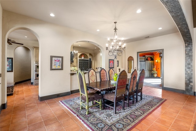 dining room with ceiling fan with notable chandelier and light tile patterned floors