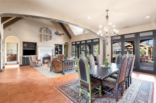 tiled dining space with ceiling fan with notable chandelier, high vaulted ceiling, french doors, and beamed ceiling