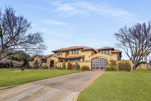 mediterranean / spanish house featuring a front yard