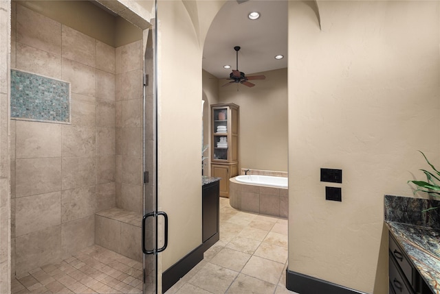 bathroom featuring plus walk in shower, tile patterned floors, vanity, and ceiling fan