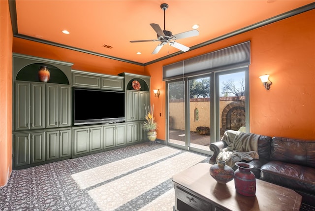 living room featuring ornamental molding, carpet, and ceiling fan