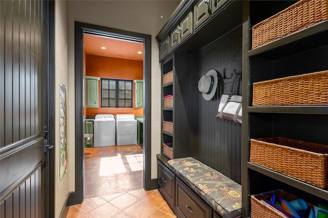 mudroom featuring light tile patterned floors and washing machine and dryer