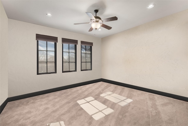 unfurnished room with light colored carpet and ceiling fan