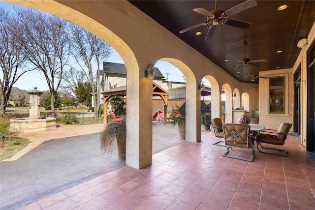 view of patio / terrace featuring a gazebo and ceiling fan