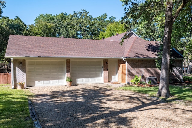 view of front facade with brick siding, an attached garage, gravel driveway, and roof with shingles