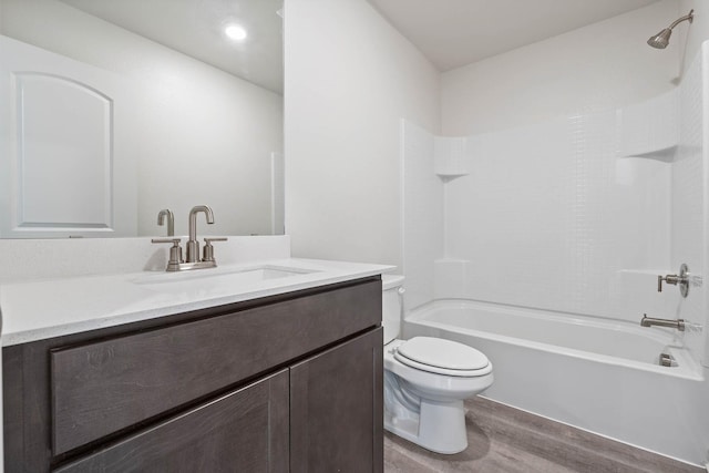 full bathroom with vanity, wood-type flooring, tub / shower combination, and toilet