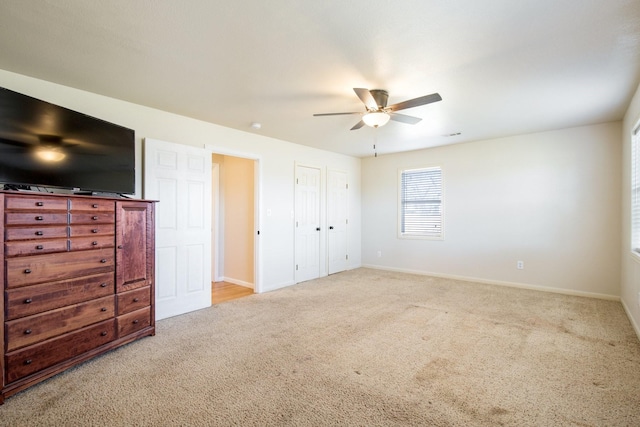 bedroom with ceiling fan and light carpet