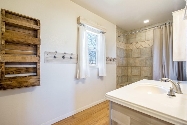 bathroom featuring hardwood / wood-style floors, sink, and a shower with shower curtain