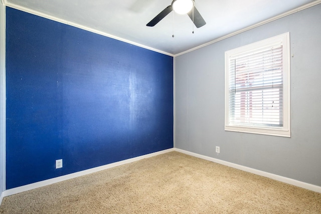 unfurnished room with ornamental molding, carpet, and ceiling fan