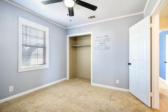 unfurnished bedroom with light carpet, ornamental molding, a closet, and ceiling fan