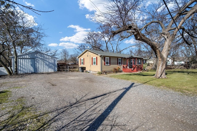 ranch-style home with an outbuilding and a front yard