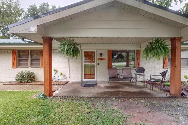 rear view of property featuring a porch