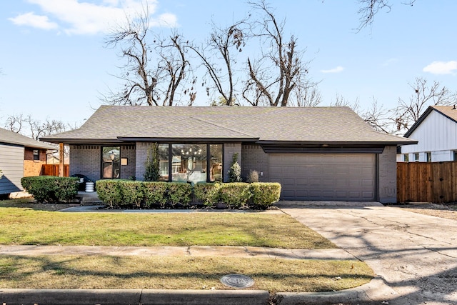 view of front of home featuring a garage and a front yard