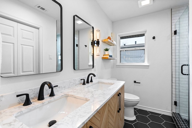 bathroom with an enclosed shower, vanity, tile patterned flooring, and toilet