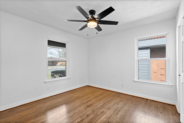 empty room featuring ceiling fan and wood-type flooring