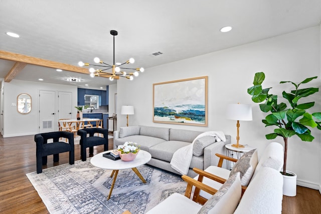 living room featuring dark hardwood / wood-style floors and an inviting chandelier