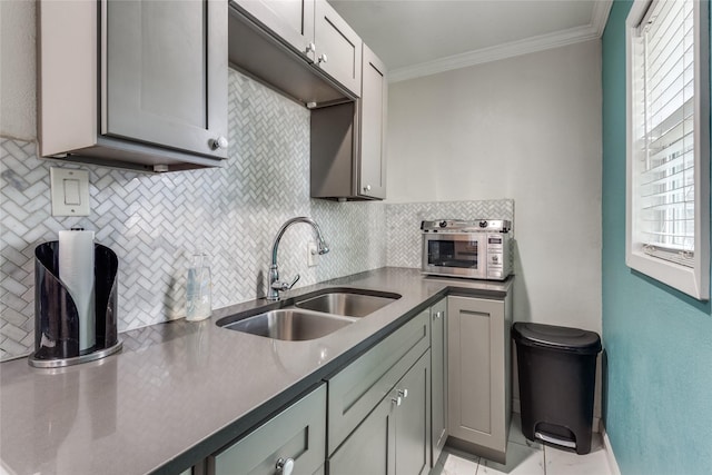 kitchen featuring crown molding, a healthy amount of sunlight, sink, and decorative backsplash