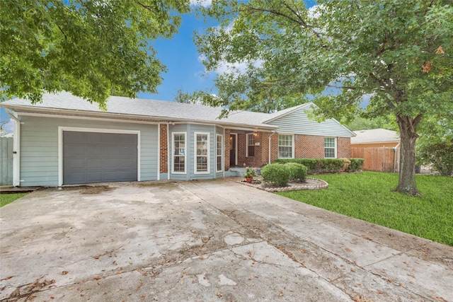 single story home featuring a garage and a front yard