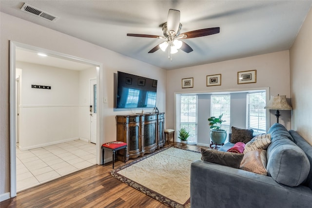 living room featuring ceiling fan and light wood-type flooring