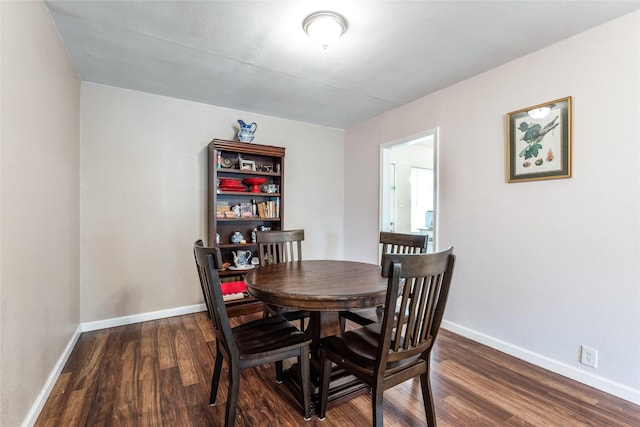 dining space with dark hardwood / wood-style flooring