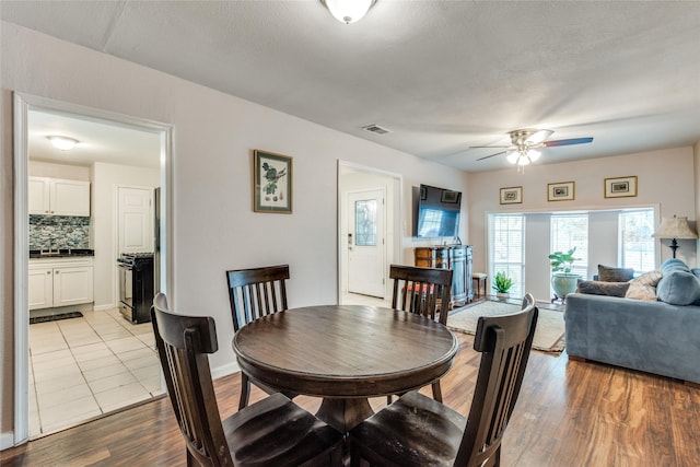 dining space featuring light hardwood / wood-style flooring and ceiling fan