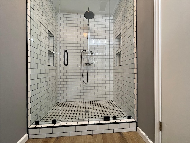 bathroom featuring hardwood / wood-style floors and walk in shower