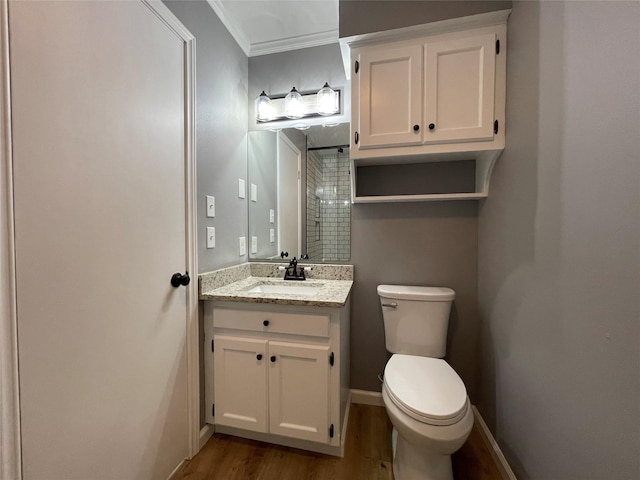 bathroom with vanity, hardwood / wood-style flooring, ornamental molding, and toilet