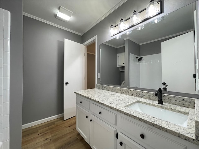 bathroom featuring walk in shower, ornamental molding, vanity, and hardwood / wood-style floors