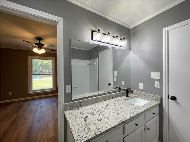 bathroom featuring crown molding, hardwood / wood-style floors, vanity, and ceiling fan