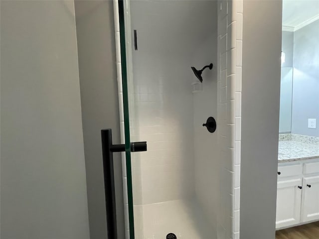 bathroom featuring hardwood / wood-style flooring, vanity, and an enclosed shower