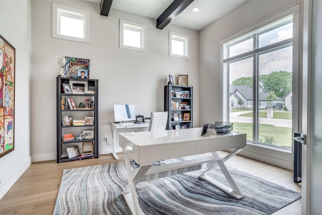 office featuring light hardwood / wood-style flooring and beamed ceiling