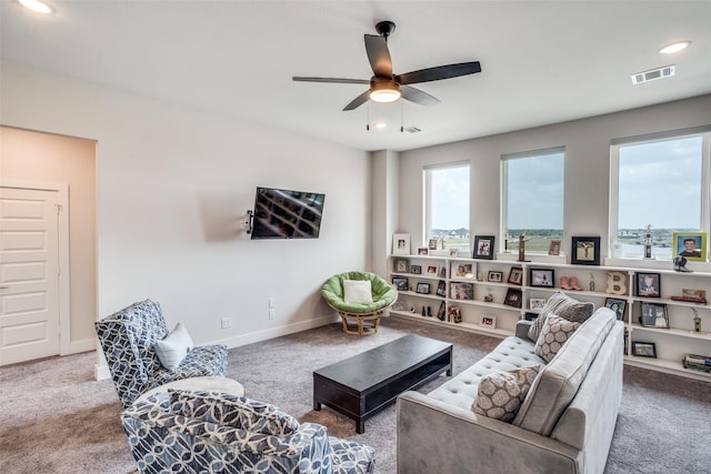 living room with ceiling fan and carpet flooring