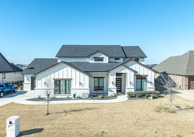 modern farmhouse style home with a front lawn