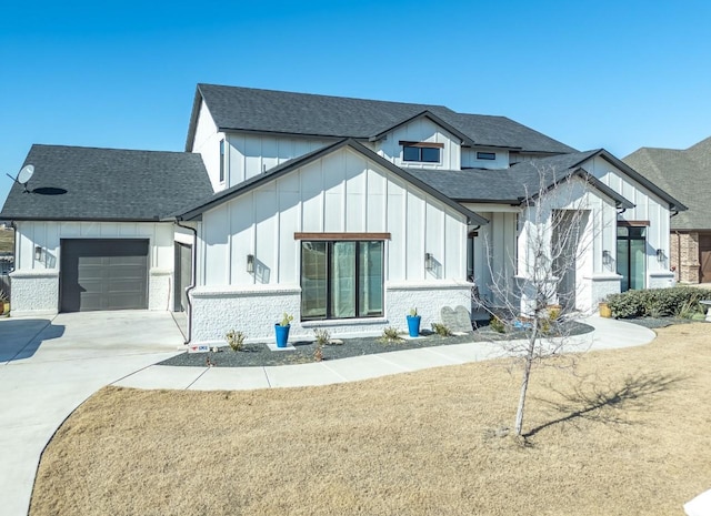 modern inspired farmhouse with a garage and a front yard