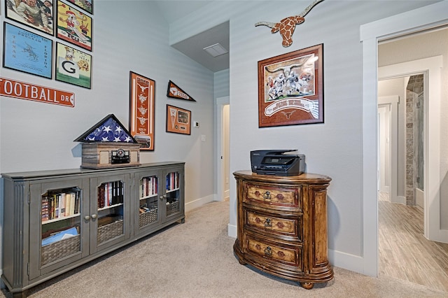 hall with light colored carpet