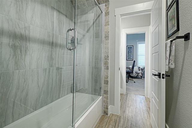 bathroom featuring a shower with shower door