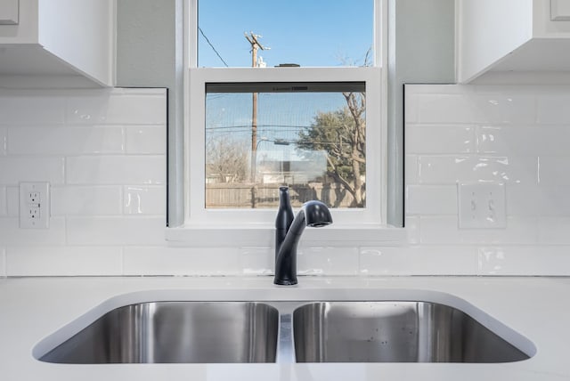 details featuring white cabinetry and sink