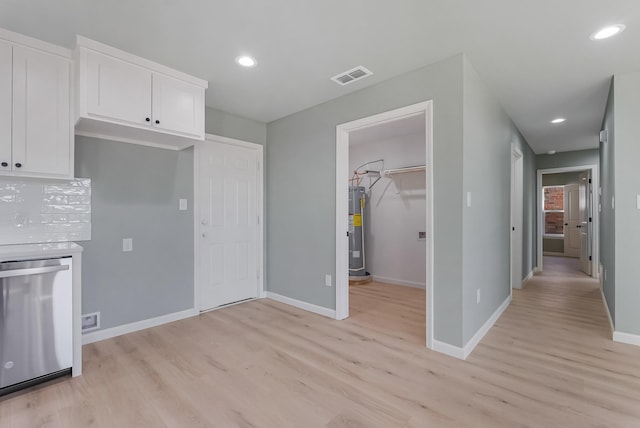 kitchen with water heater, white cabinetry, dishwasher, and light hardwood / wood-style flooring