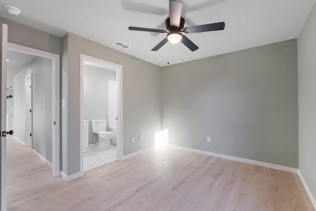 unfurnished bedroom featuring light hardwood / wood-style floors, ceiling fan, and ensuite bathroom