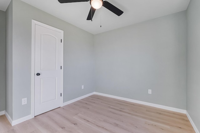 empty room with ceiling fan and light wood-type flooring