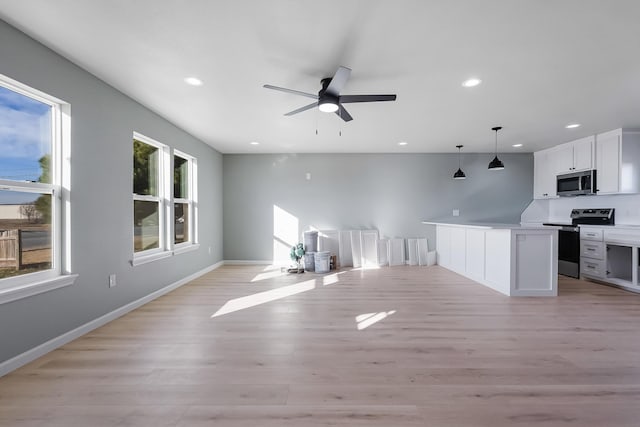 unfurnished living room featuring light hardwood / wood-style floors and ceiling fan