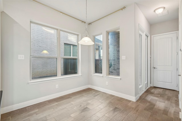 unfurnished dining area with light hardwood / wood-style floors