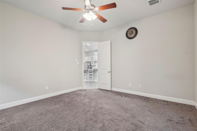 carpeted spare room with ceiling fan