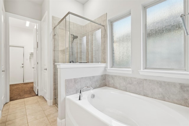 bathroom with separate shower and tub and tile patterned floors