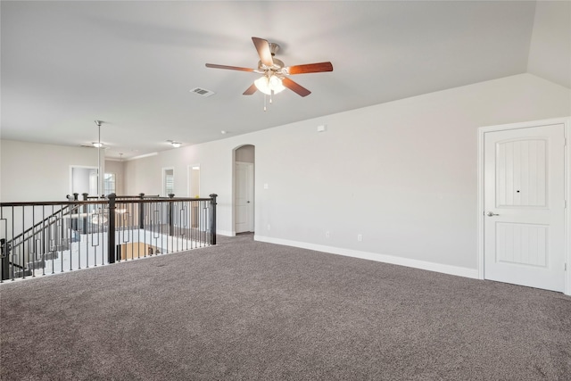 carpeted empty room with vaulted ceiling and ceiling fan