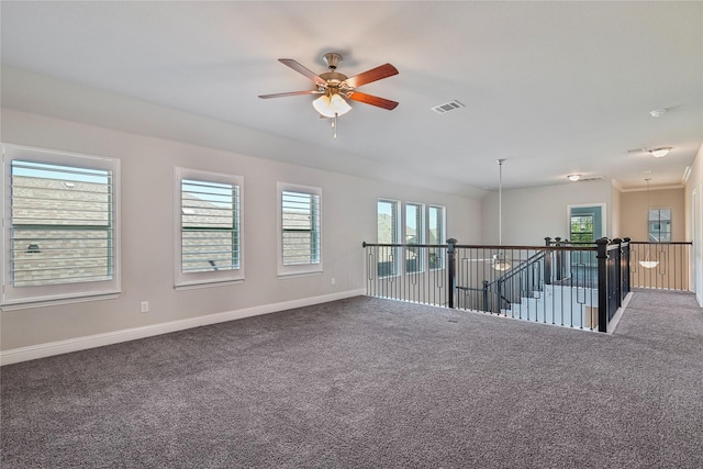 carpeted spare room with ceiling fan